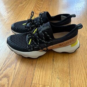 Sorel Black Slip-On Sneakers with Tan Heel Band and Yellow Accents